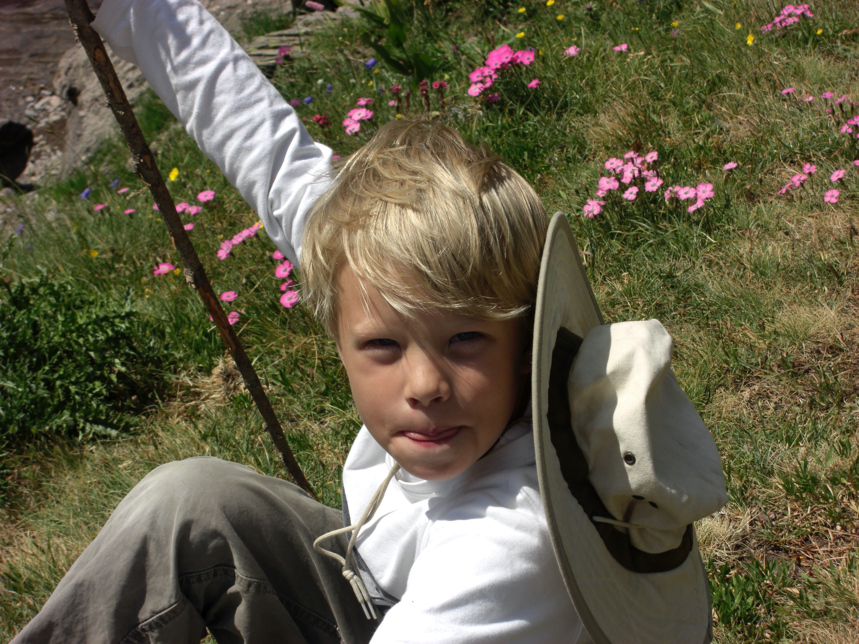 A child that is standing in the grass

Description automatically generated